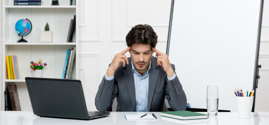 confused businessman sitting on his office